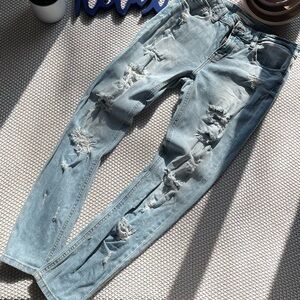 Boot cut, ripped denim jeans.